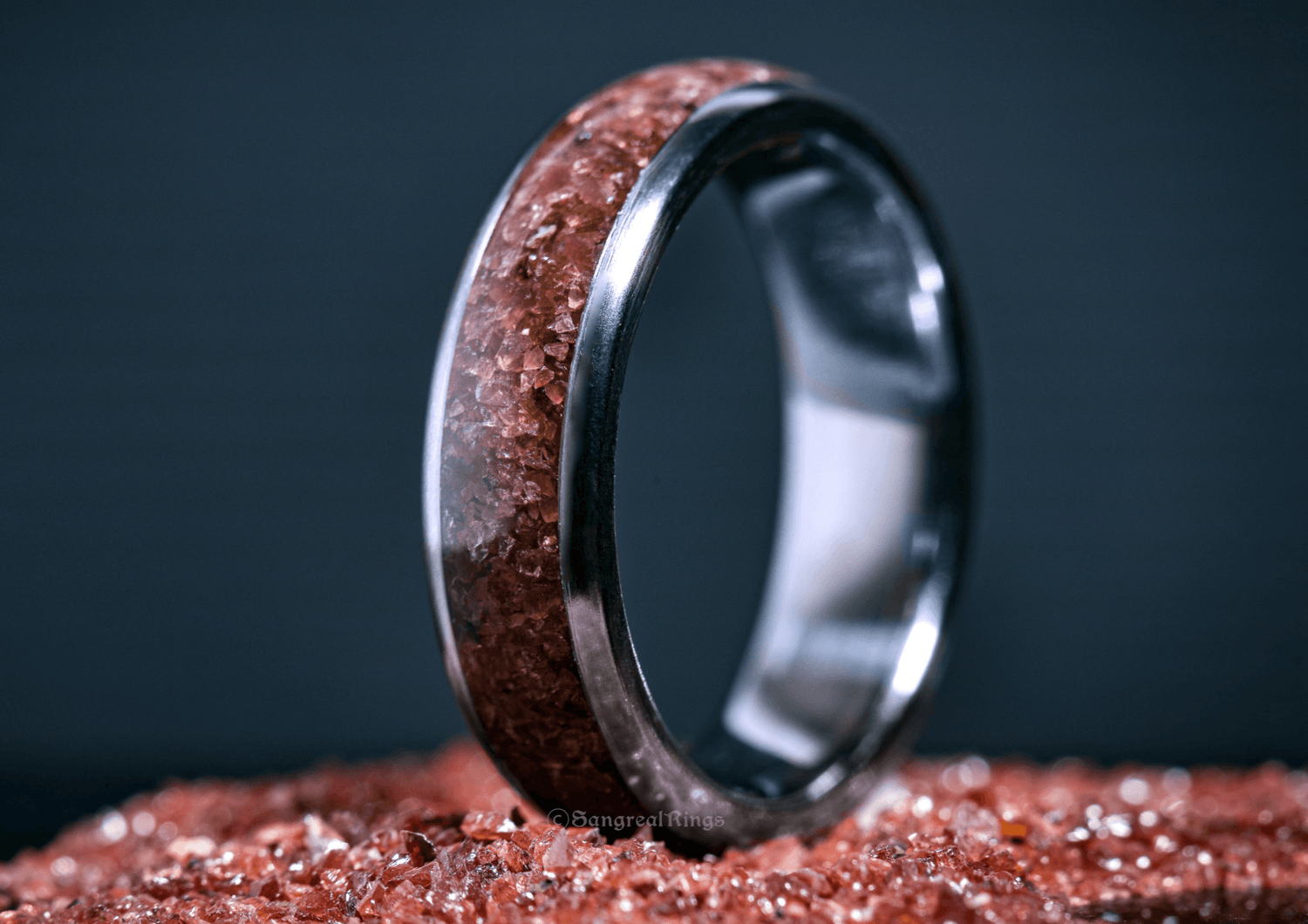 Custom garnet titanium ring from Sangreal Rings with embedded red garnet crystals in a polished titanium band