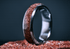 Custom garnet titanium ring from Sangreal Rings with embedded red garnet crystals in a polished titanium band