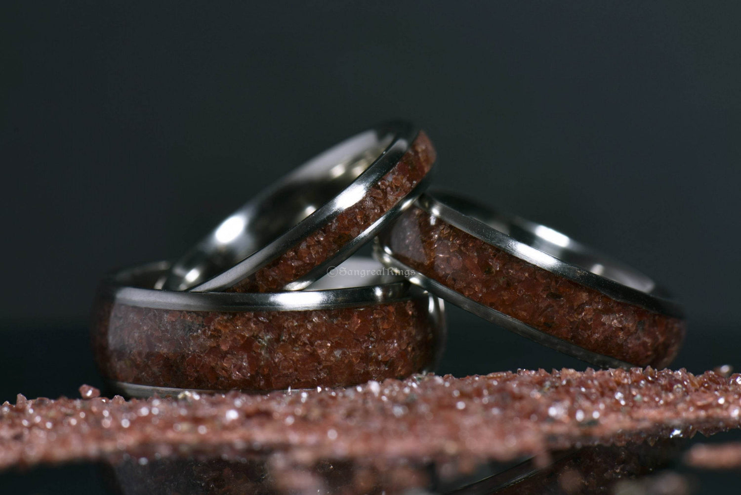 Custom garnet titanium ring set with deep red crystal inlays by Sangreal Rings