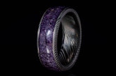 Damascus steel amethyst ring with intricate metal pattern and polished purple amethyst inlay