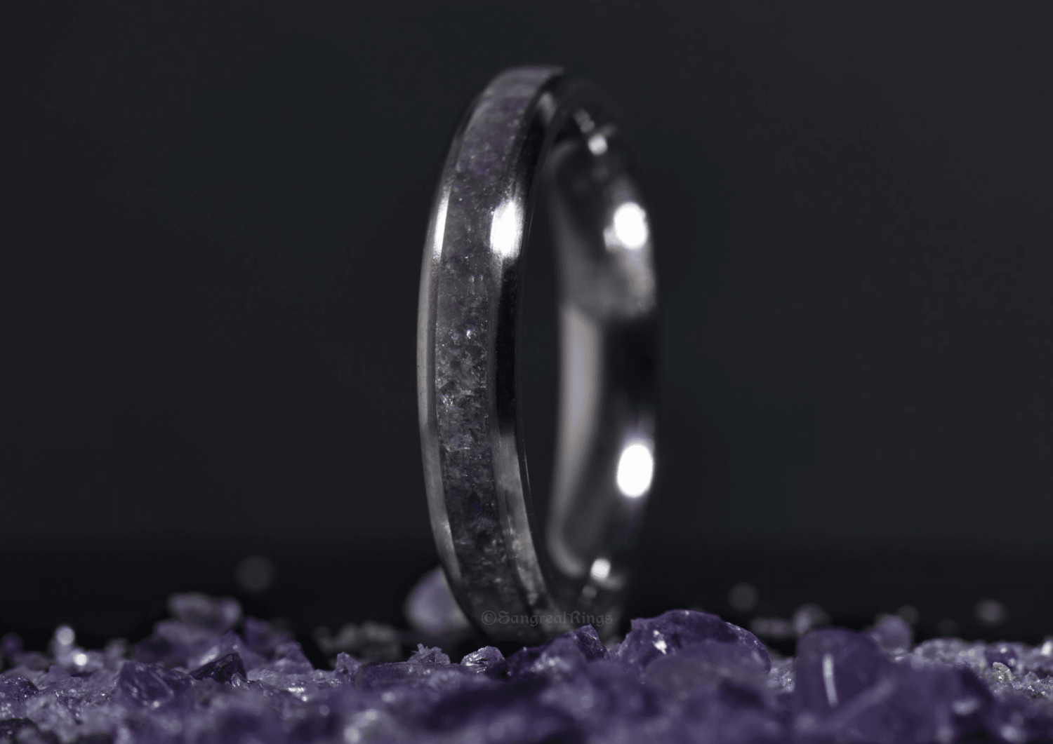 Sangreal Rings amethyst titanium ring with purple crystal inlay on dark background