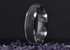 Sangreal Rings amethyst titanium ring with purple crystal inlay on a bed of amethyst stones