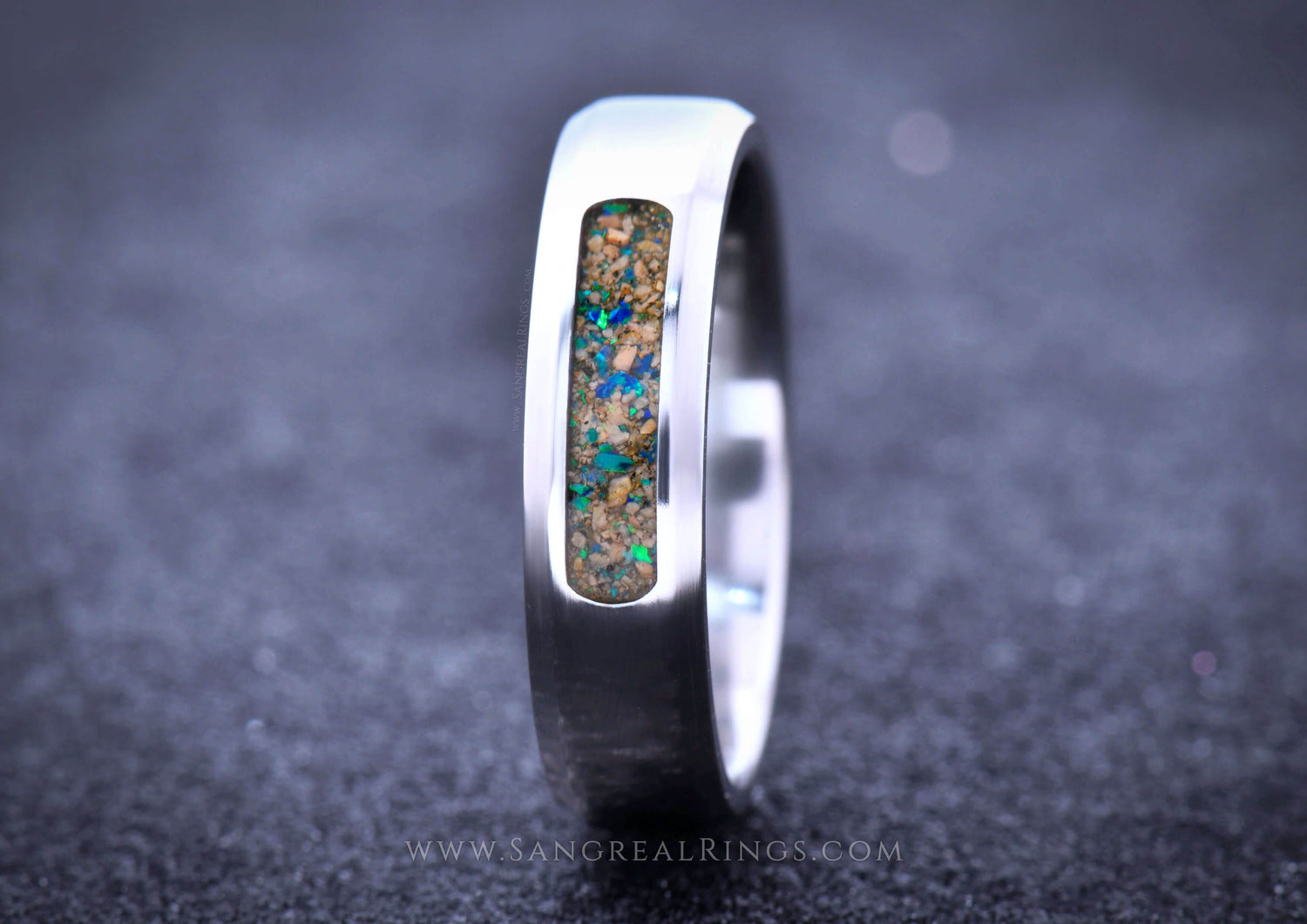 Custom titanium wedding band featuring an inlay of colorful opal stone for a unique design