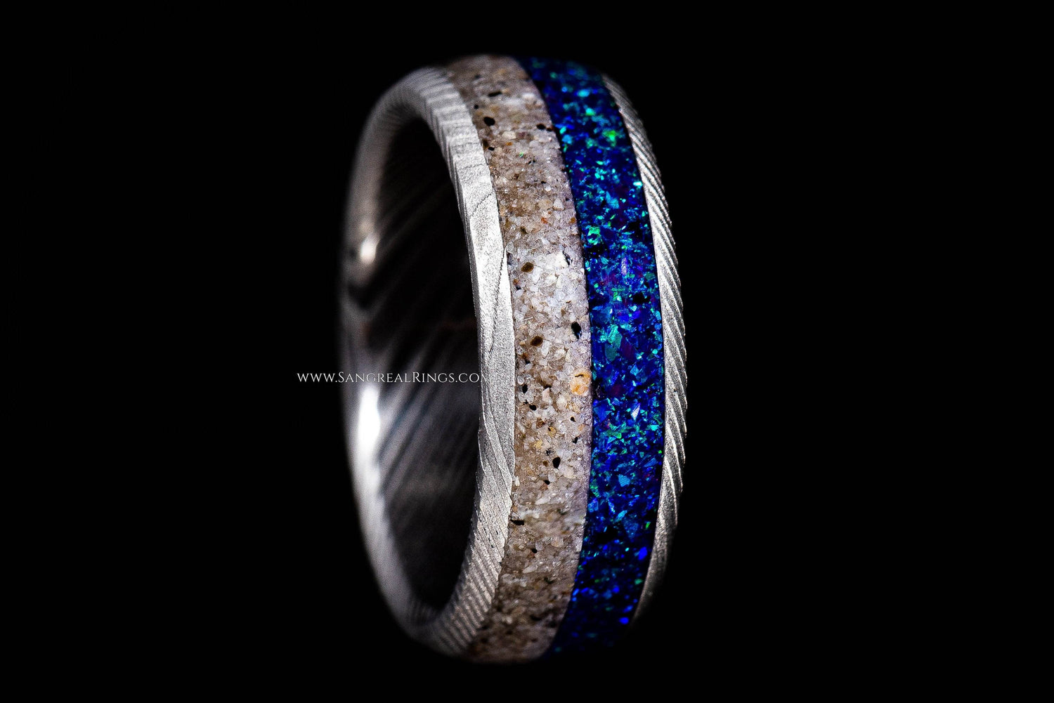 Sangreal Rings Damascus steel sand ring with sandy beige inlay and shimmering blue opal stripe