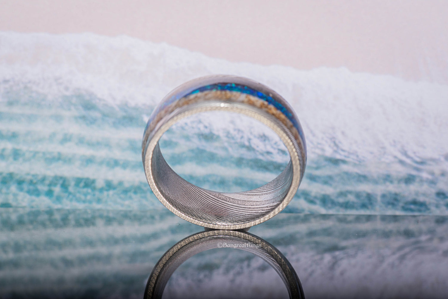 Sangreal Rings Damascus steel sand ring with ocean inspired blue inlay and textured Damascus pattern
