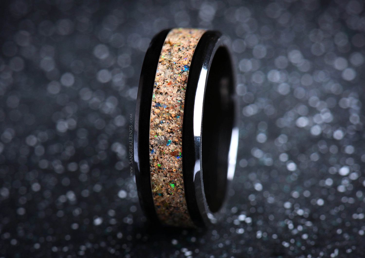 Black ceramic sand ring with a textured sand inlay and glossy black edges from Sangreal Rings