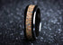Black ceramic sand ring with a textured sand inlay and glossy black edges from Sangreal Rings