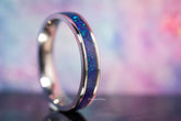 Purple opal titanium ring with vibrant blue and purple hues and polished silver edges by Sangrealrings