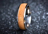 Sangreal Rings titanium sand ring with polished silver edges and sandy textured inlay on dark background