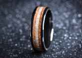 Sangreal Rings black ceramic sand ring with wood and sand inlay on dark bokeh background