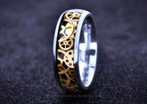 Sangrealrings titanium steampunk ring with gold gear inlay and polished silver edges on black backdrop