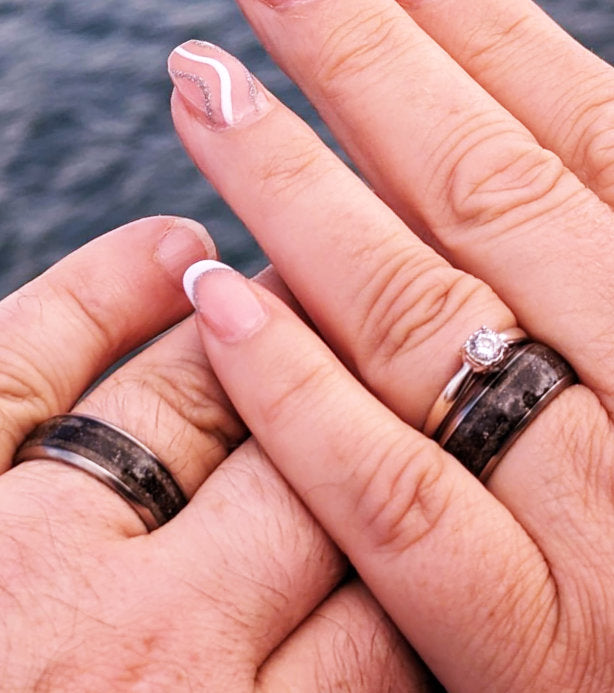 up close shot of two hands with split inlay sand rings on fingers