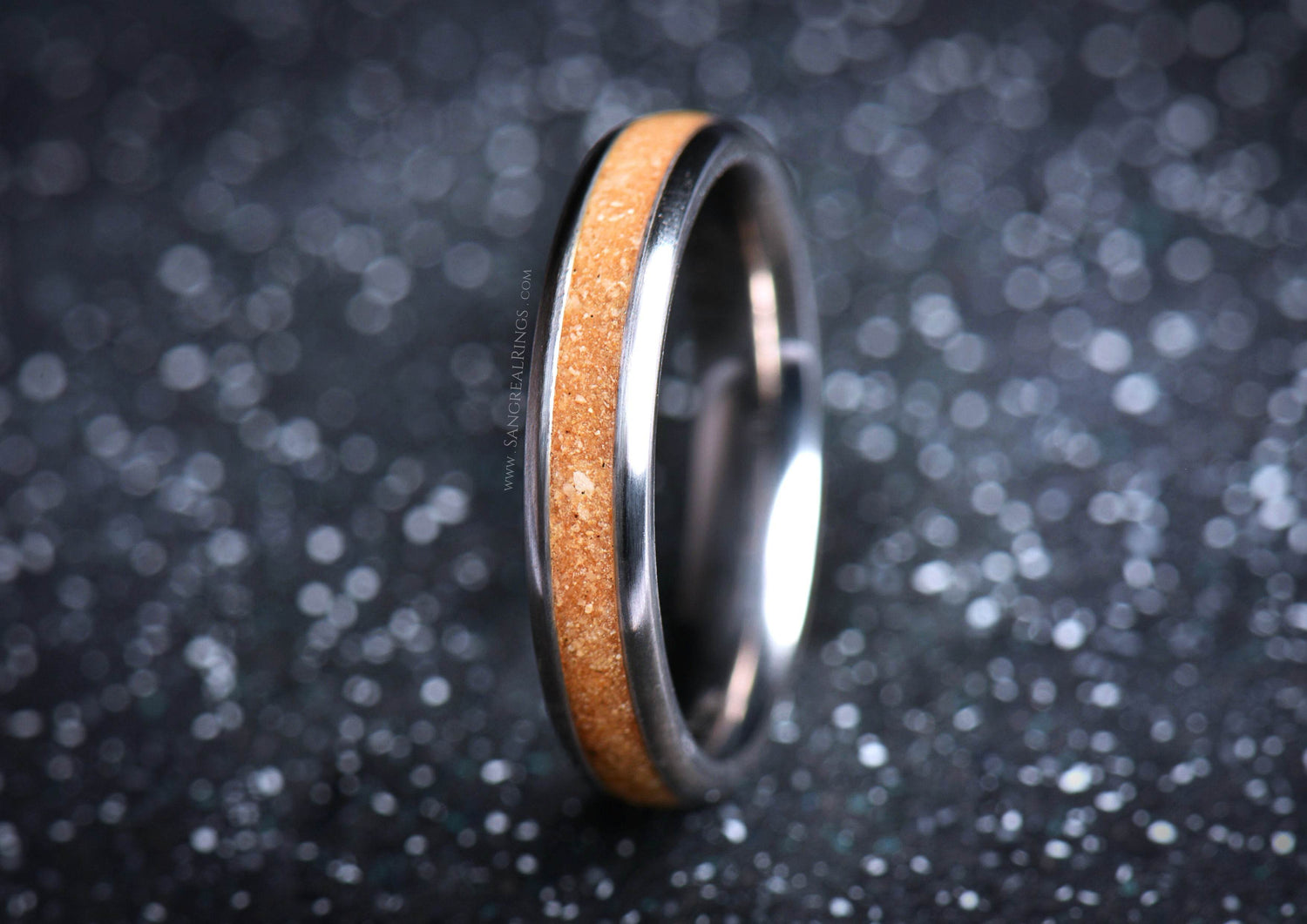 Sleek titanium sand ring by Sangreal Rings with smooth metallic finish and sandy inlay