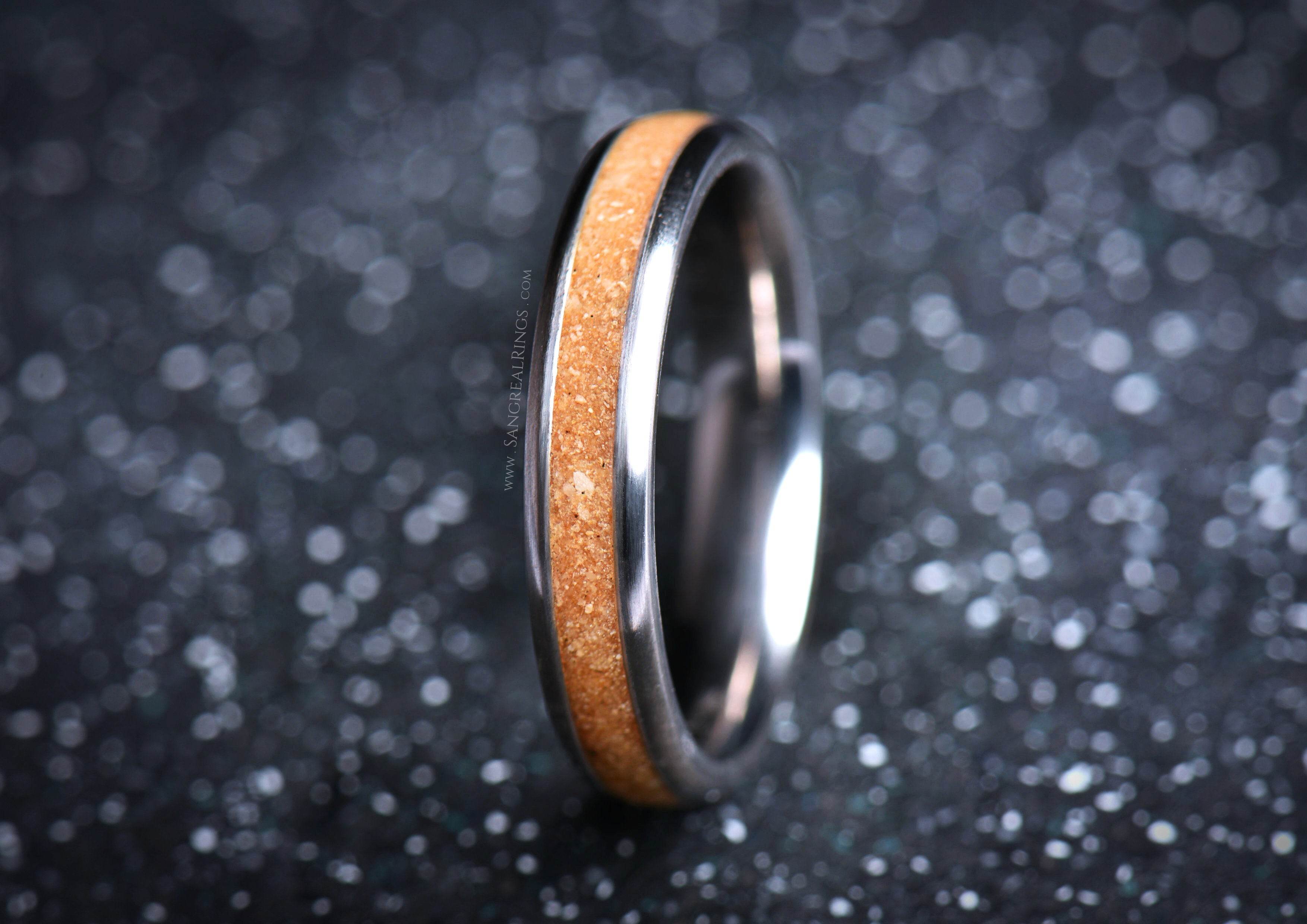 Sleek titanium sand ring by Sangreal Rings with smooth metallic finish and sandy inlay