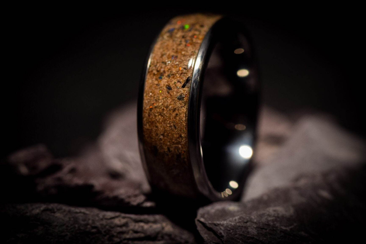 Sangrealrings opal dinosaur bone ring with polished black metal band and detailed fossil inlay
