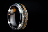 Sangreal Rings titanium sand ring with shimmering sand and blue accents on a metallic band