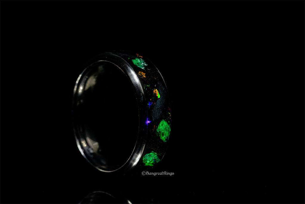Sleek black titanium jurassic ring with green and gold accents by Sangrealrings
