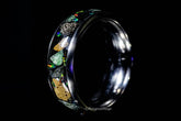 Sangrealrings titanium jurassic ring with embedded colorful stones and fossil fragments on black background
