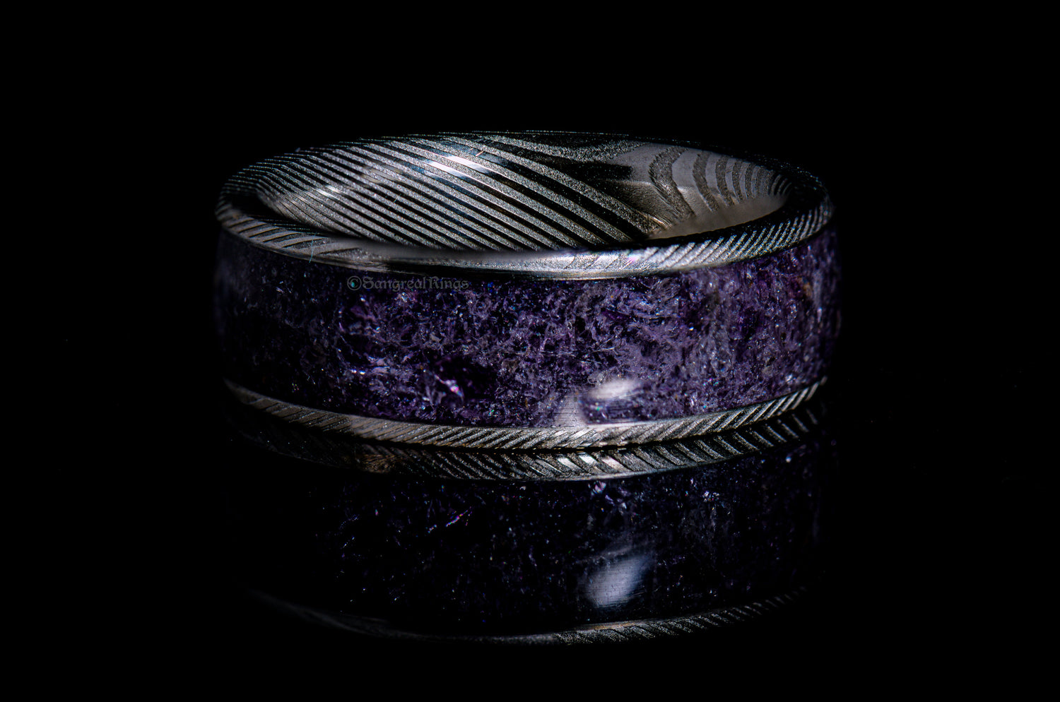 Elegant custom gemstone rings featuring deep purple stones and intricate metalwork design