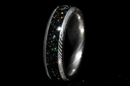Custom Damascus steel sand inlay wedding band with textured edges and dark glittering inlay by Sangreal Rings