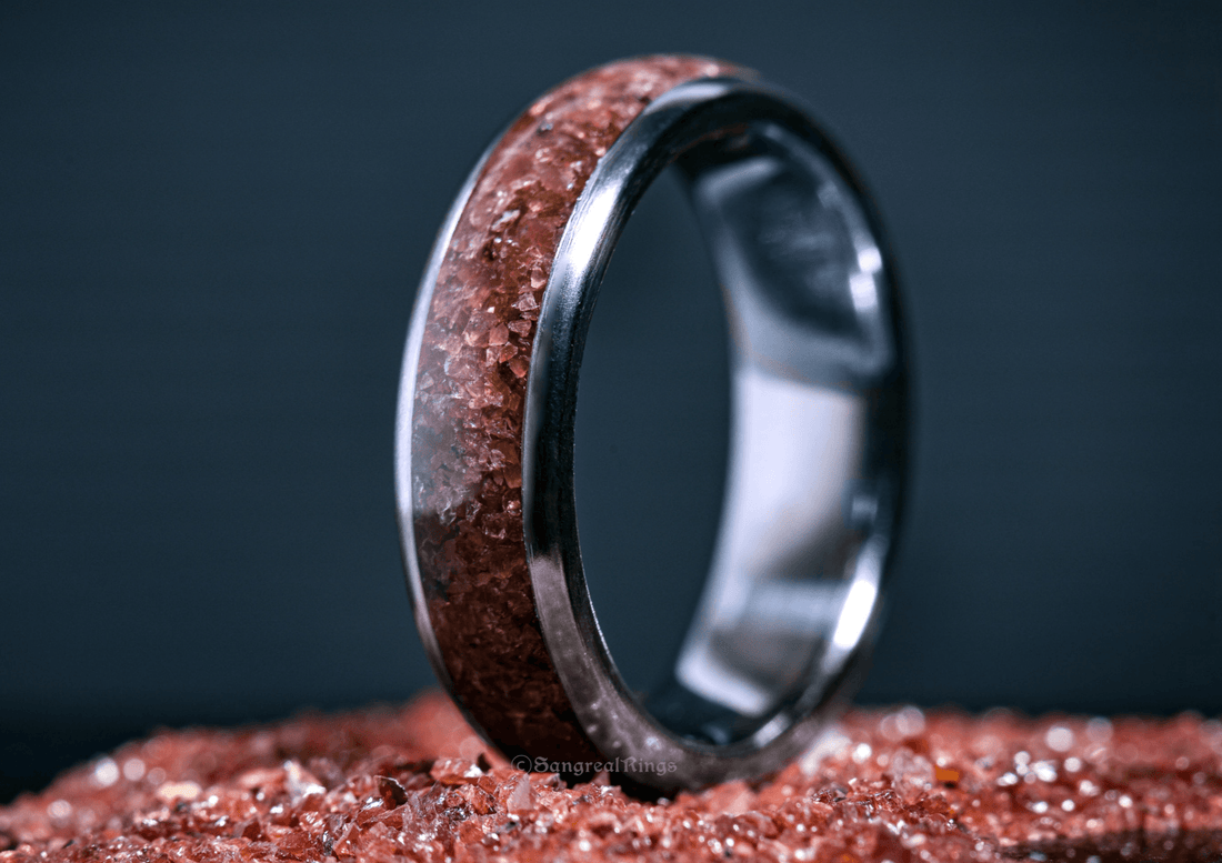 Custom garnet titanium ring from Sangreal Rings with embedded red garnet crystals in a polished titanium band