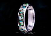 Custom titanium memorial keepsake ring with cremation ashes and multicolored opal inlay on a dark background, handcrafted in the UK by Sangreal Rings.
