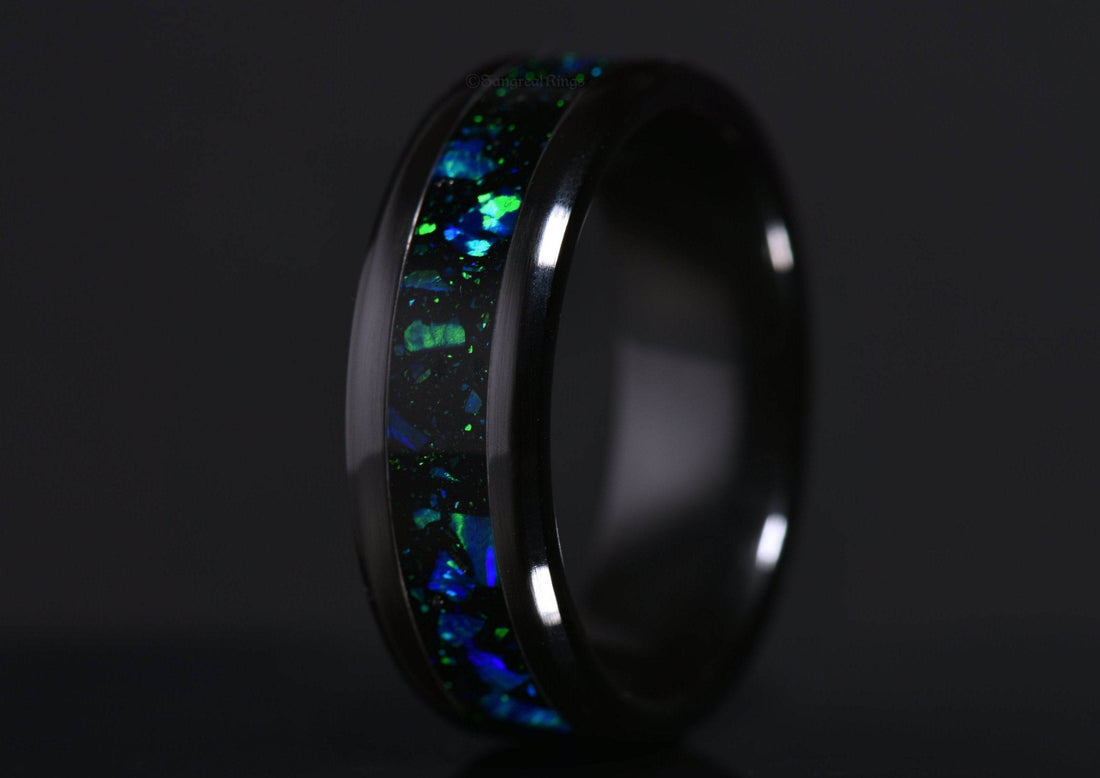 Sleek onyx and blue opal ring by Sangreal Rings with vibrant iridescent inlay on black band