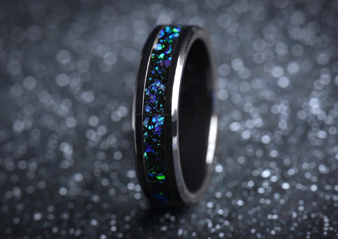 Sleek onyx and purple opal ring with vibrant blue and green inlays on black band by Sangreal Rings