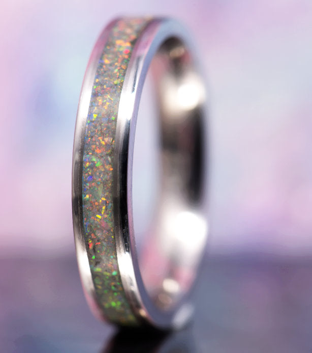 a slim silver ring with an inlay of white opal