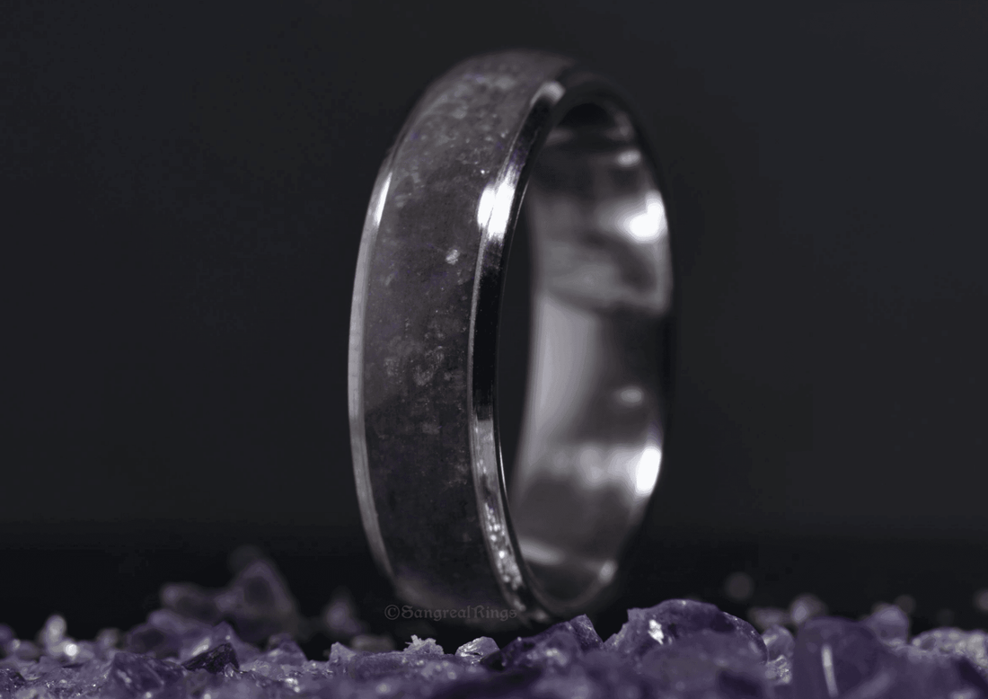Sangreal Rings amethyst titanium ring with purple crystal inlay on a bed of amethyst stones
