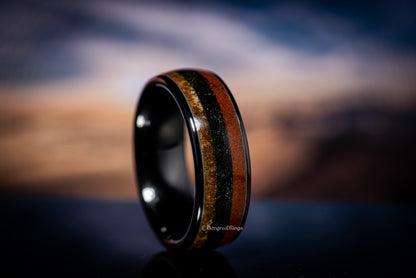 Sangreal Rings black ceramic sand ring with layered orange and gold sand texture band