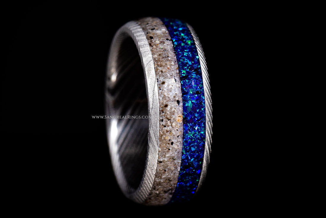 Sangreal Rings Damascus steel sand ring featuring blue and sand inlay with textured edges