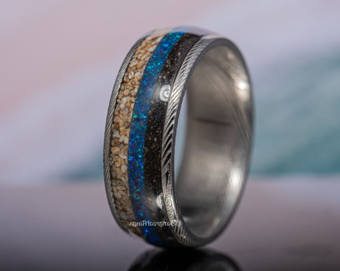 Damascus steel sand ring with blue and sand-colored inlays by Sangreal Rings