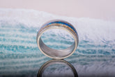 Close-up of Damascus steel sand ring with blue and gold sand details by Sangreal Rings
