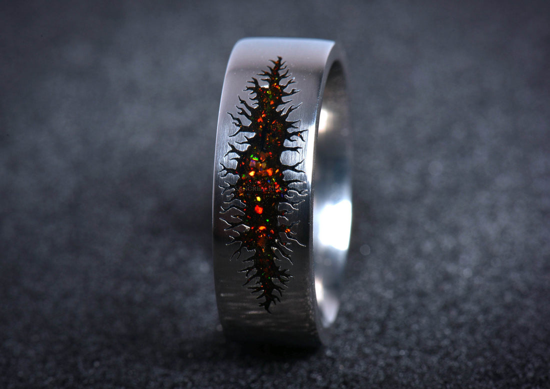 Black titanium band with fiery opal inlay and jagged fissure design unique alternative mens galaxy ring band