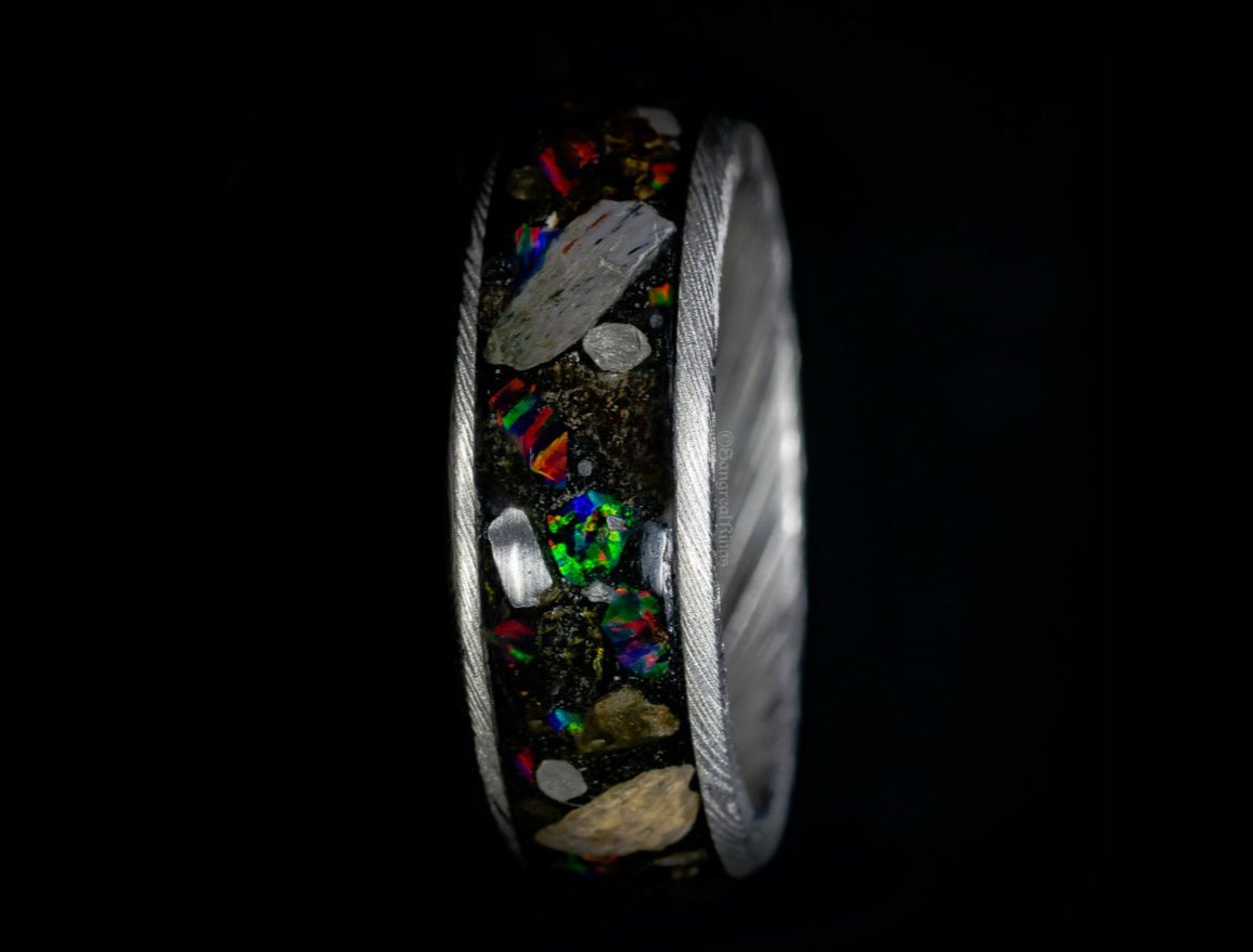 fossil and meteorite ring with diamond shards and opal on a dark background by sangrealrings