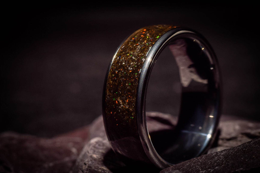 Opal megalodon tooth meteorite ring with shimmering iridescent inlay and polished black band by Sangrealrings