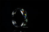 Sangrealrings titanium jurassic ring with colorful embedded stone design on black background